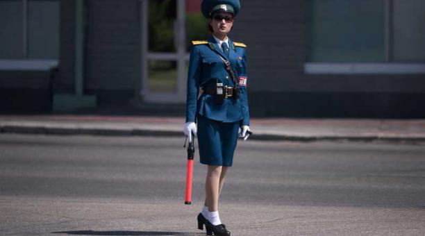 En una foto tomada el 4 de junio de 2017 un oficial de seguridad de tránsito está de servicio en una intersección en Pyongyang. Oficialmente conocidos como agentes de seguridad de tránsito pero universalmente llamados señoras del tráfico. Foto: AFP